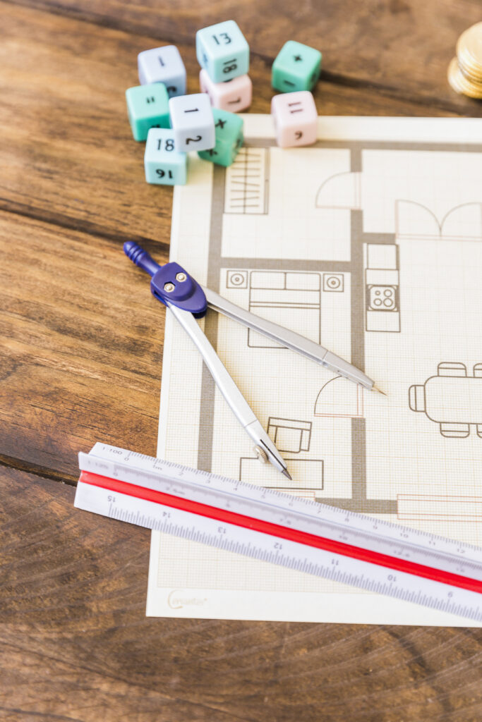 close-up-divider-ruler-math-blocks-blueprint-wooden-desk