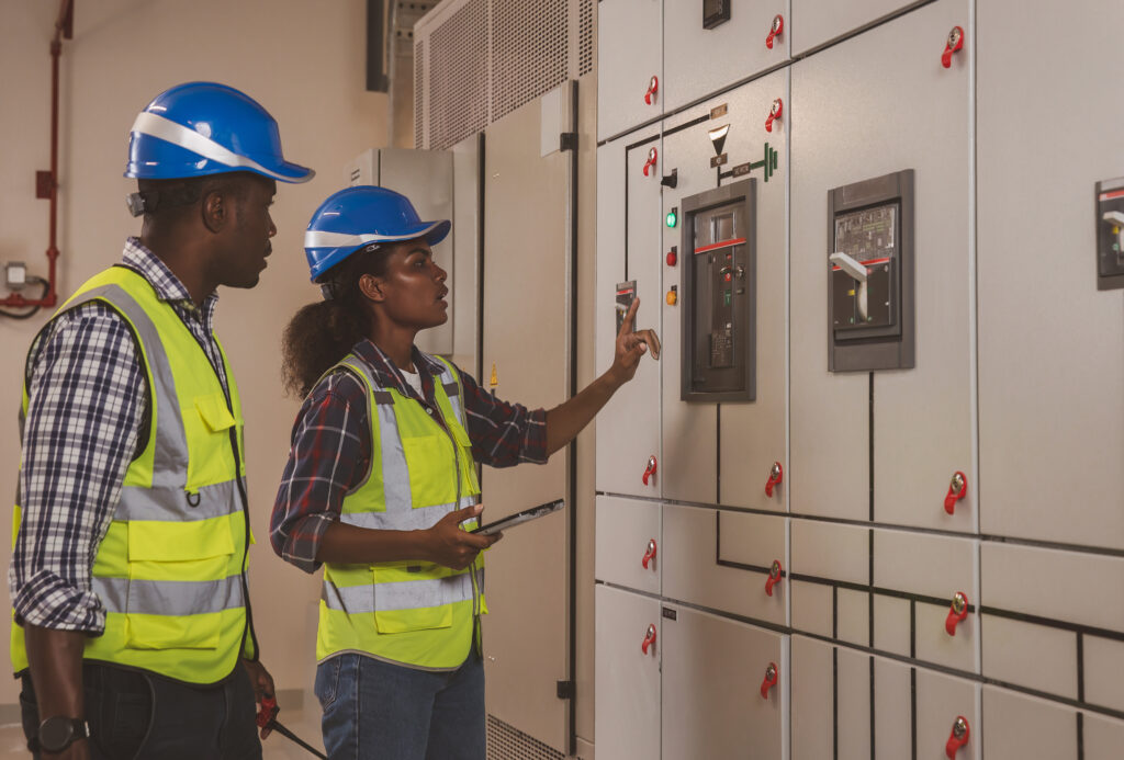 Electrical engineer working in control room. Electrical engineer