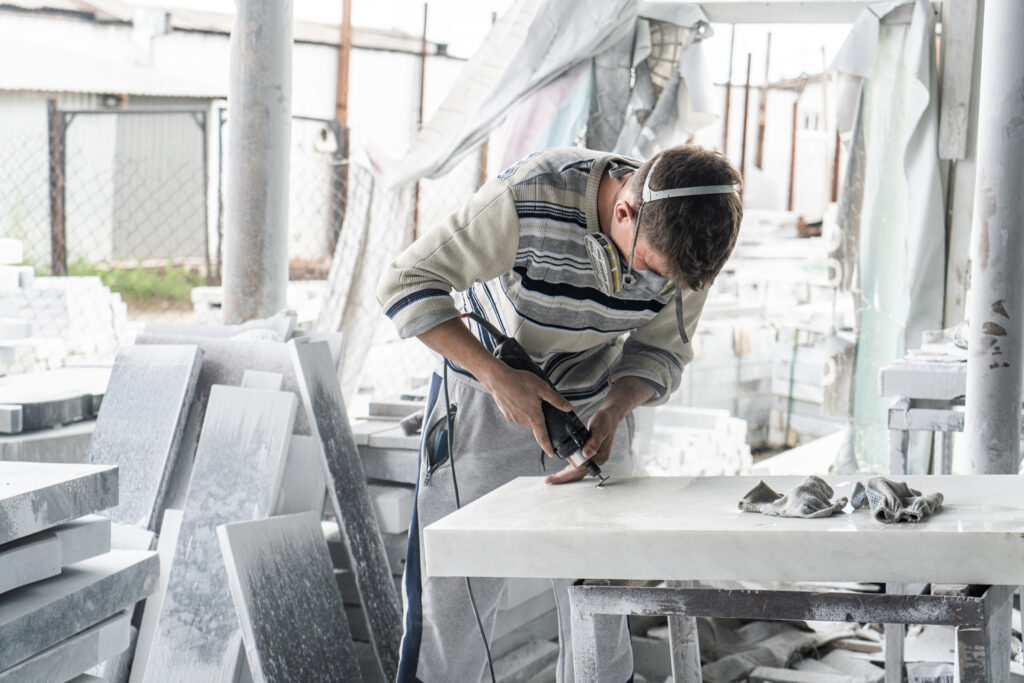 The master engraves the tombstone. Stone processing